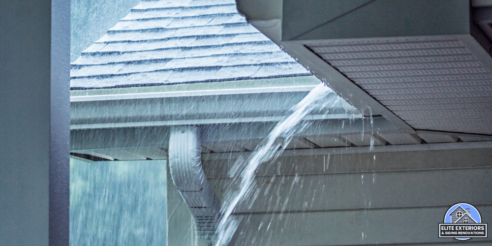 Rainwater overflowing an eavestrough at a roof corner during heavy rain